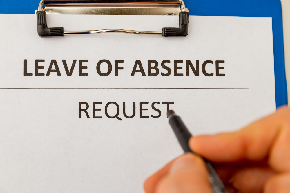 eave of absence request on the tablet at the table.